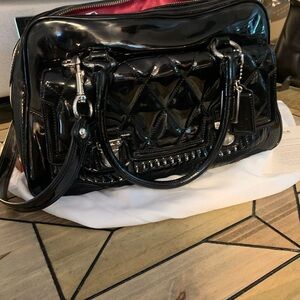 Quilted black patent black pink lining Coach bag.